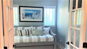 a living room with a couch in a room with windows at 717 Broadway in West Cape May