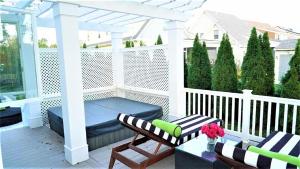 a porch with a pergola and a table and chairs at 717 Broadway in West Cape May