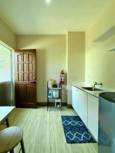 an empty kitchen with a sink and a door at Boboy's Guest House in Daro
