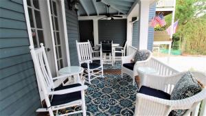 a porch with chairs and a table on a house at Heritage House 2 in Cape May