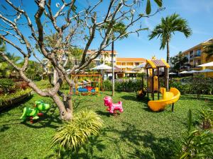 a playground with play equipment in a yard at Sen Village Hoi An in Hoi An