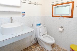 a bathroom with a toilet and a sink and a window at Tao Thong Villa 2 in Ko Tao +233 photos