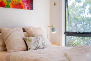 a bedroom with a bed with a window at Studio 216 - Oceanview Studio with Bath, Romantic Bruny Escape in Alonnah