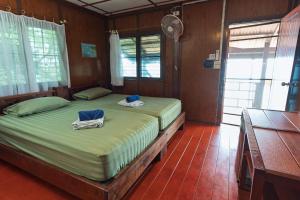 a bedroom with two twin beds with towels on them at Tao Thong Villa 2 in Ko Tao