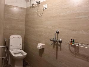 a bathroom with a toilet and a shower at The Manzil Boho in Darjeeling