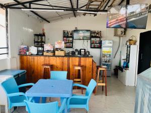 a restaurant with blue tables and chairs and a counter at Luanda City Hostel in Luanda