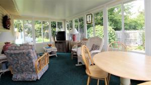 a living room with a table and chairs at 12 Mechanic St in West Cape May +14 photos