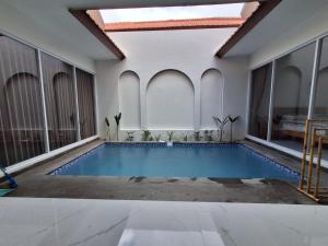 a swimming pool in a room with a ceiling at Villa Luck Canggu Bali unit 8 in Canggu