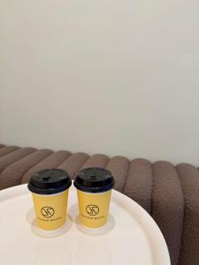 two coffee cups sitting on top of a table at 逢甲25行館Fengjia 25 Hotel in Taichung +13 photos