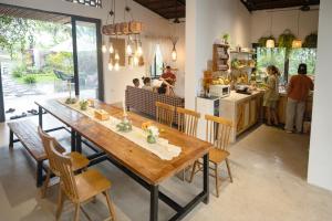 a dining room with a wooden table and chairs at KuTÓN ECOCAMP in Lương Sơn