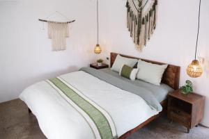 a bed in a white room with pendant lights at KuTÓN ECOCAMP in Lương Sơn +64 photos