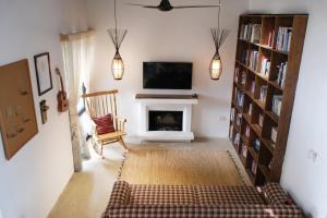 a living room with a tv and a fireplace at KuTÓN ECOCAMP in Lương Sơn
