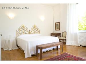 a white bedroom with a bed and a table at B&B Albaro in Genoa