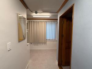 a hallway with a door to a room with a window at Gyeongju MaMa in Gyeongju +55 photos