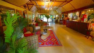 a living room with a dog sitting on a rug at Le Vasa Resort in Fuailalo