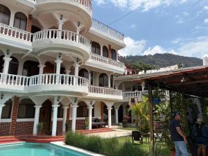 a large building with a pool in front of it at Gutierrez Hotel in Panajachel