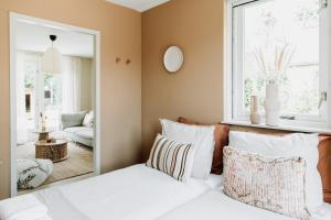 a bedroom with a bed and a mirror at Bohemian Wellness met hottub & sauna in Ewijk