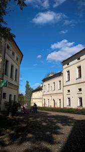 a group of buildings with a person on a motorcycle in front at 8pokoi OFKA in Cieszyn