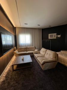 a living room with a couch and a coffee table at Safety house in Tabuk