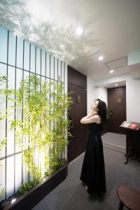 a woman standing in an office looking at a plant at ryeoan seomyeon in Busan