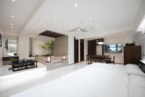 a bedroom with a large bed and a living room at ryeoan seomyeon in Busan +90 photos