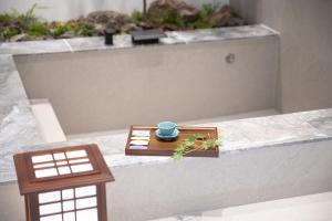 a bath tub with a table with a cup on it at ryeoan seomyeon in Busan