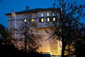 a building with lights in the windows at night at 4 Seasons in Vizitsa in Vyzitsa