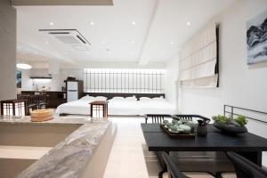 a living room with a bed and a dining table at ryeoan seomyeon in Busan