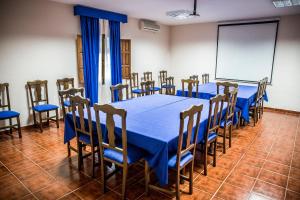 a conference room with a blue table and chairs at Hospedium Hotel Val de Pinares in Bogarra +113 photos