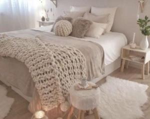 a bedroom with a bed with a crocheted blanket at Loire-Gerbier-Mézenc in Sainte-Eulalie