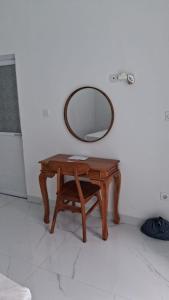 a wooden table with a mirror on a wall at Villa Luck Canggu Bali unit 8 in Canggu