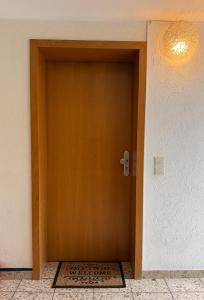 a brown door in a room with a rug at Appartement eleven in Duisburg