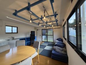 a living room with a table and a couch at Exsaison SETOUCHI in Sakaide