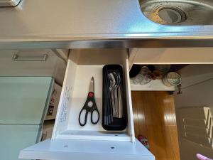 a pair of scissors sitting on a shelf in a kitchen at Exsaison SETOUCHI in Sakaide +16 photos