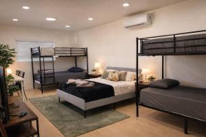 a bedroom with two bunk beds in a room at The Olympic Suites LA in Los Angeles