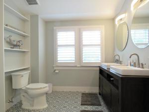 a bathroom with a toilet and a sink and a mirror at The Sunrise On Sunset in West Cape May +28 photos