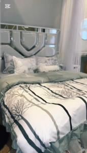 a bedroom with a bed with white sheets at Malaika homes in Kampala
