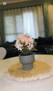 a small vase with flowers on a table at Malaika homes in Kampala