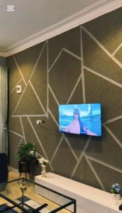 a tv on a wall in a room at Malaika homes in Kampala