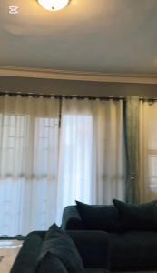 a living room with a couch in front of a window at Malaika homes in Kampala