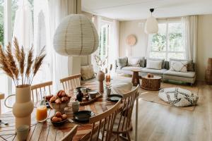 a living room with a table with a bowl of fruit at Bohemian Wellness met hottub & sauna in Ewijk