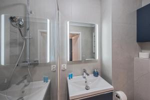 a bathroom with a sink and a shower at Azure Mostek Oldtown in Gdańsk