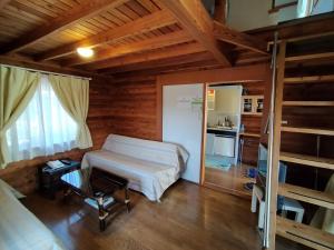 a bedroom with a bed and bunk beds in a room at Cottage&Pension Love Thirty in Karuizawa