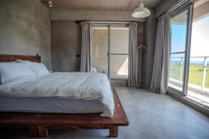 a bedroom with a bed and a large window at Tomoya in Chenggong