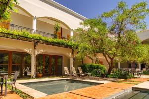 a house with a swimming pool in a yard at Hotel Boutique Las Hortensias in Pilar