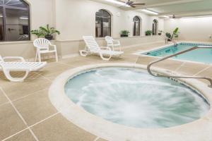 a large pool with chairs and a hot tub at Baymont by Wyndham Asheville/Biltmore in Asheville