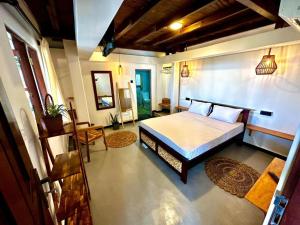 a bedroom with a large bed in a room at surf dom hotel & restaurants in Ahangama