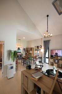 a large living room with a table and chairs at Mango Villa แมงโก้ วิลล่า in Sa Kaeo