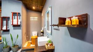 a bathroom with a sink and a mirror at Cozora Nook - Sigiriya in Sigiriya