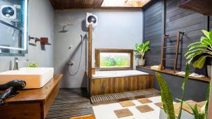 a bathroom with a sink and a bath tub at Cozora Nook - Sigiriya in Sigiriya +45 photos